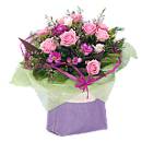 Rose & Freesia Fantasy - An enchanting hand-tied flower bouquet with pink Roses and pink Freesias complemented by rich green foliage.