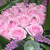 Regal Decadence (�64.99) - A regal bouquet of compact pink roses with tiny jewels placed between the petals, surrounded by velvety purple calla lilies. 