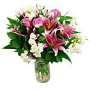 The Cascade Bouquet, an arrangement overflowing with lilies, freesia and roses in gorgeous pink, white and cerise tones.